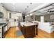 Spacious kitchen with island, farmhouse sink, stainless appliances, and an open view to the living room at 321 Third Ave, Knightdale, NC 27545