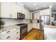 Bright kitchen with stainless steel appliances, granite countertops, and a classic subway tile backsplash at 321 Third Ave, Knightdale, NC 27545