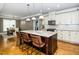Kitchen island with seating and stainless appliances, opens to breakfast nook and seating for entertaining at 321 Third Ave, Knightdale, NC 27545