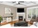 Cozy living room with a fireplace and coffered ceilings, perfect for gatherings at 321 Third Ave, Knightdale, NC 27545