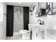 Modern bathroom with dual sinks, black hardware and finishes, and stylish shower with black accents at 323 W 5Th St, Burlington, NC 27215