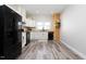 Modern kitchen featuring white cabinetry, butcher block countertops, and stainless steel appliances at 323 W 5Th St, Burlington, NC 27215