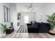 Comfortable living room featuring a fireplace, ceiling fan, and large sectional sofa at 323 W 5Th St, Burlington, NC 27215