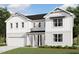 Charming two-story home with a welcoming front porch, attached garage, and manicured lawn at 3300 Clairmeade Dr # 164 Prescott Fh, Fuquay Varina, NC 27526