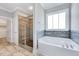 Bathroom featuring a tub, a glass enclosed shower, and tile floors at 358 Ashpole Trl, Clayton, NC 27520
