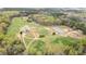 Scenic aerial view of horse property featuring a house, fields, pond, and outbuildings at 3880 L Lawrence Trl, Graham, NC 27253