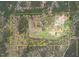 Aerial view showcasing approximate lot lines of vast land with pastures and woodland at 3880 L Lawrence Trl, Graham, NC 27253
