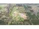 An expansive aerial shot of a homestead including pastureland and woodlands at 3880 L Lawrence Trl, Graham, NC 27253