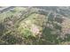 Aerial view showcases a vast property with a pond, house, barns and verdant landscape with natural beauty at 3880 L Lawrence Trl, Graham, NC 27253