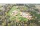 Aerial view of a beautiful property featuring open fields, wooded areas, pond, home and horse facilities at 3880 L Lawrence Trl, Graham, NC 27253