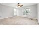 Bedroom featuring neutral walls, carpet, ceiling fan and a double window at 3880 L Lawrence Trl, Graham, NC 27253