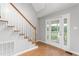 Entryway with staircase and view to front porch through glass door at 3880 L Lawrence Trl, Graham, NC 27253