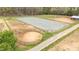Aerial view of equestrian arena surrounded by fields and trees at 3880 L Lawrence Trl, Graham, NC 27253