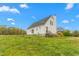 Exterior view of home featuring grassy yard and partial landscape at 3880 L Lawrence Trl, Graham, NC 27253