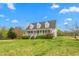 Beautiful white home with a long front porch and blue skies at 3880 L Lawrence Trl, Graham, NC 27253