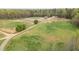 Aerial view of a farm, with fields, trees and the barn, creating a tranquil landscape at 3880 L Lawrence Trl, Graham, NC 27253