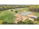Aerial shot of a farm with a house, equestrian facilities, and pastures at 3880 L Lawrence Trl, Graham, NC 27253