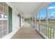 Covered front porch showcasing the outdoor living space and scenery at 3880 L Lawrence Trl, Graham, NC 27253