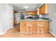 Eat-in kitchen with breakfast bar, laminate wood floors and appliances at 3880 L Lawrence Trl, Graham, NC 27253