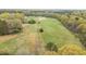 Scenic aerial view of property featuring extensive land and a charming house nestled amidst nature at 3880 L Lawrence Trl, Graham, NC 27253