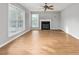 Spacious living room with large windows, ceiling fan and fireplace at 3880 L Lawrence Trl, Graham, NC 27253