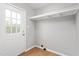 Mud room with laminate floors, white door and shelving at 3880 L Lawrence Trl, Graham, NC 27253