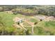 Aerial view showcasing a large property featuring home, ponds, and horse facilities at 3880 L Lawrence Trl, Graham, NC 27253