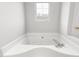 Bathroom featuring a white jacuzzi tub with chrome faucet at 3880 L Lawrence Trl, Graham, NC 27253