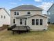 The back of this house boasts a tan paint job and a charming back porch at 3914 Glorybower Way, Apex, NC 27502