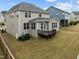 The back of this house boasts a tan paint job and a charming back porch at 3914 Glorybower Way, Apex, NC 27502