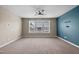 Bright bedroom with large windows offering ample natural light and neutral-colored walls and carpeting at 3914 Glorybower Way, Apex, NC 27502