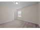 Bedroom with neutral carpet, window, and view of hallway and doorway at 3914 Glorybower Way, Apex, NC 27502