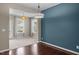 Bright dining room with neutral walls, two windows with white curtains, and a chandelier light fixture at 3914 Glorybower Way, Apex, NC 27502