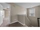 Upstairs hallway view with beige walls and neutral carpet leading to another room at 3914 Glorybower Way, Apex, NC 27502