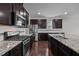 Gourmet kitchen with stainless steel appliances, granite countertops, and dark wood cabinetry at 3914 Glorybower Way, Apex, NC 27502