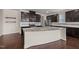 Modern kitchen showcasing dark cabinets, granite countertops, and stainless steel appliances at 3914 Glorybower Way, Apex, NC 27502