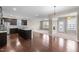 Open floor plan featuring a kitchen with dark wood cabinets and stainless appliances at 3914 Glorybower Way, Apex, NC 27502