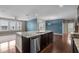 Open-concept kitchen with granite island, stainless appliances, and access to adjacent living areas at 3914 Glorybower Way, Apex, NC 27502