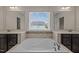 Close up of soaking tub featuring tile surround and mosaic tile at 3914 Glorybower Way, Apex, NC 27502