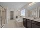 Bright bathroom with tile floors, soaking tub, walk-in shower, and double vanity at 3914 Glorybower Way, Apex, NC 27502