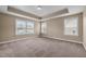 Spacious bedroom with neutral carpet, trey ceiling, and natural light from multiple windows at 3914 Glorybower Way, Apex, NC 27502