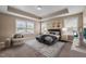 Stylishly furnished bedroom with a trey ceiling, neutral carpet, and natural light from multiple windows at 3914 Glorybower Way, Apex, NC 27502