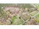 Aerial view showcasing a home and outbuilding surrounded by trees and a large, well-maintained lawn at 4018 Moon Lindley Rd, Snow Camp, NC 27349