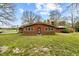 Brick home in a large backyard, complemented by mature trees and greenery at 4018 Moon Lindley Rd, Snow Camp, NC 27349