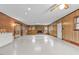 Bright basement area with wood paneled walls, brick details and access to outdoor space at 4018 Moon Lindley Rd, Snow Camp, NC 27349