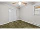 This bedroom features a ceiling fan, a double door closet, and a bright window at 4018 Moon Lindley Rd, Snow Camp, NC 27349