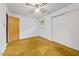 This bedroom features a ceiling fan, a double door closet, and a window at 4018 Moon Lindley Rd, Snow Camp, NC 27349