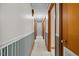 Hallway featuring wood doors, decorative wallpaper, and access to carpeted stairs at 4018 Moon Lindley Rd, Snow Camp, NC 27349