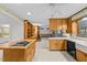 An eat-in kitchen featuring a cooktop island, and adjacent to a brick fireplace at 4018 Moon Lindley Rd, Snow Camp, NC 27349