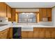 This kitchen features wood cabinetry and a large undermount sink with window at 4018 Moon Lindley Rd, Snow Camp, NC 27349